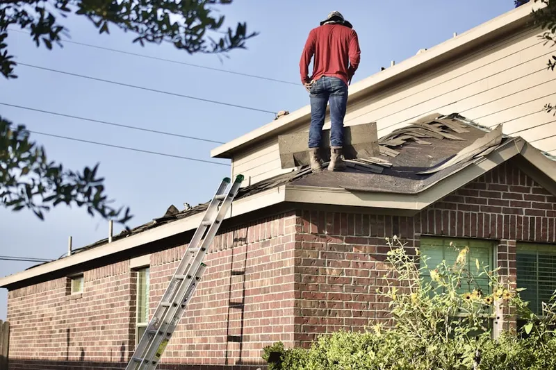 Professional roofer working on a residential roof in Moyock